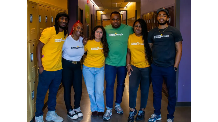 Anthony Hargrove with community members at a school.