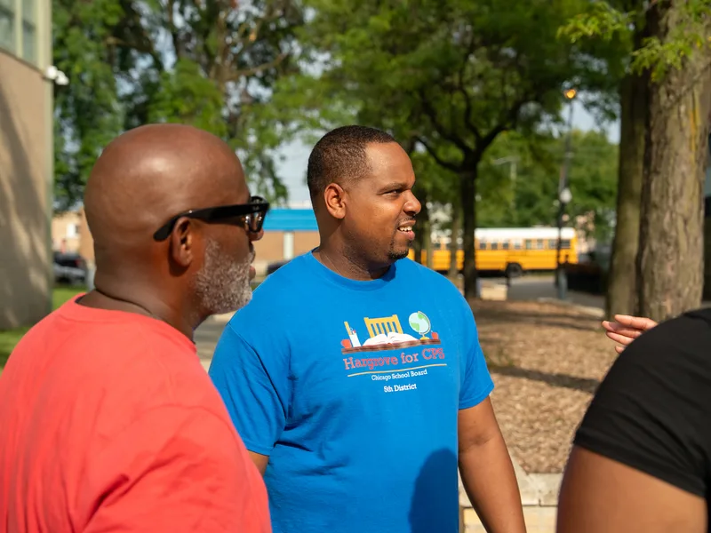 Anthony Hargrove in profile speaking with someone outdoors.