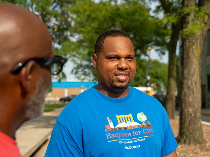Close portrait of Anthony Hargrove in a blue shirt during an outdoor gathering.