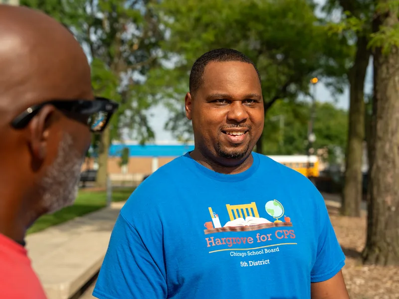 Anthony Hargrove in a blue shirt looking toward the camera outdoors.
