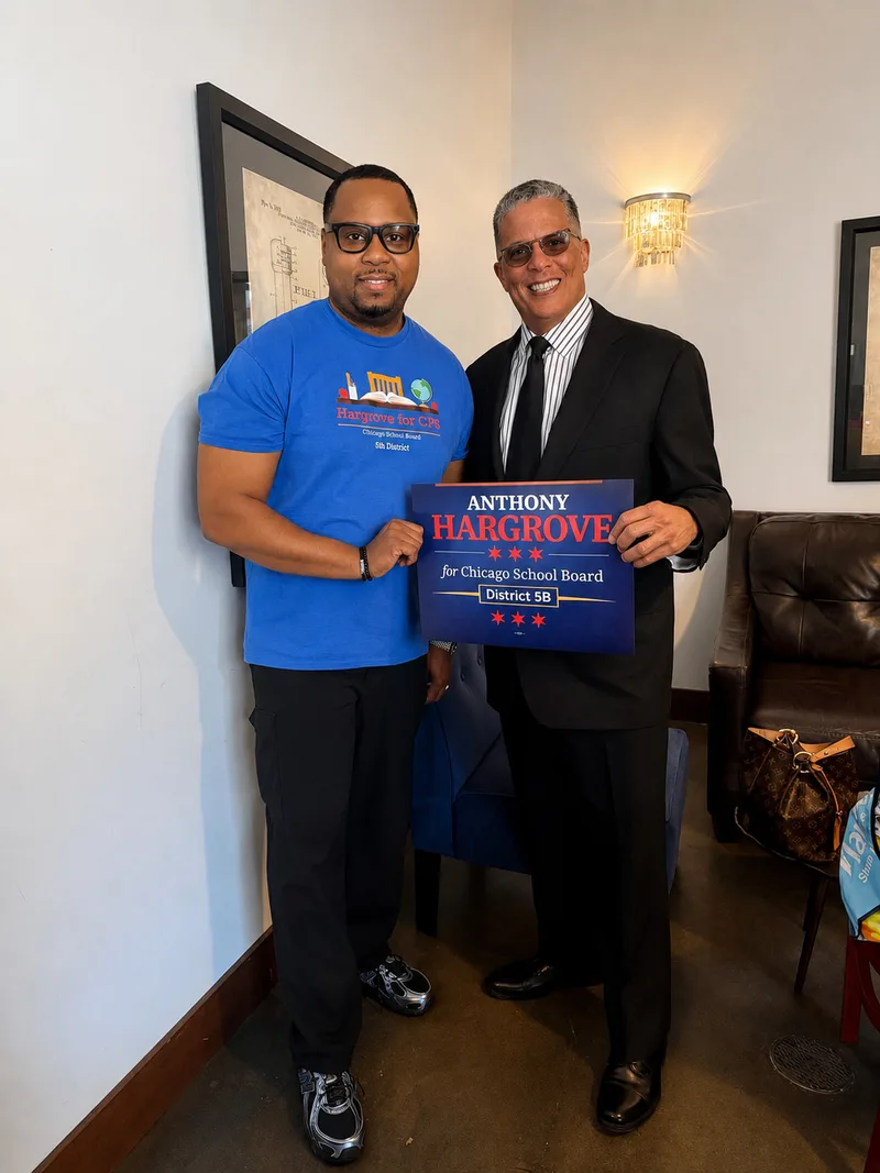 Anthony Hargrove standing beside a man in formal attire holding an Anthony Hargrove campaign sign.