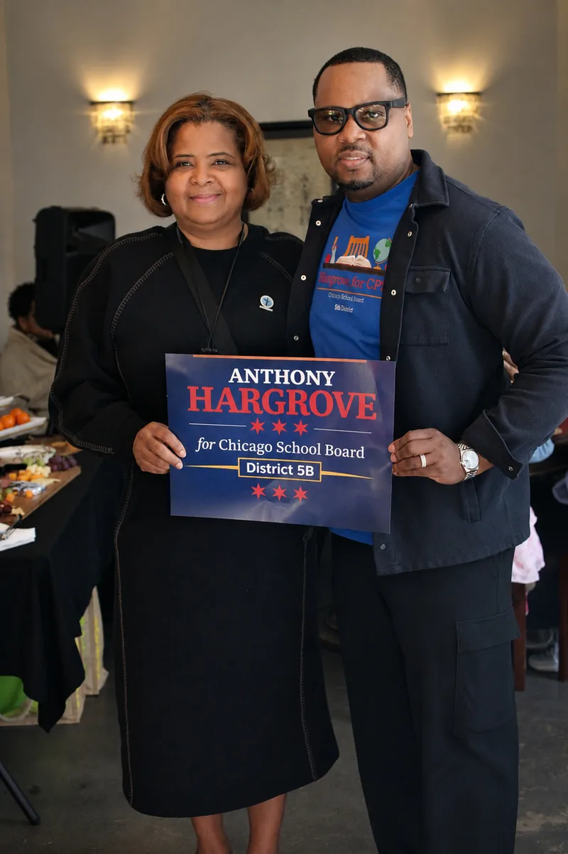 Anthony Hargrove standing beside a woman holding an Anthony Hargrove campaign sign.