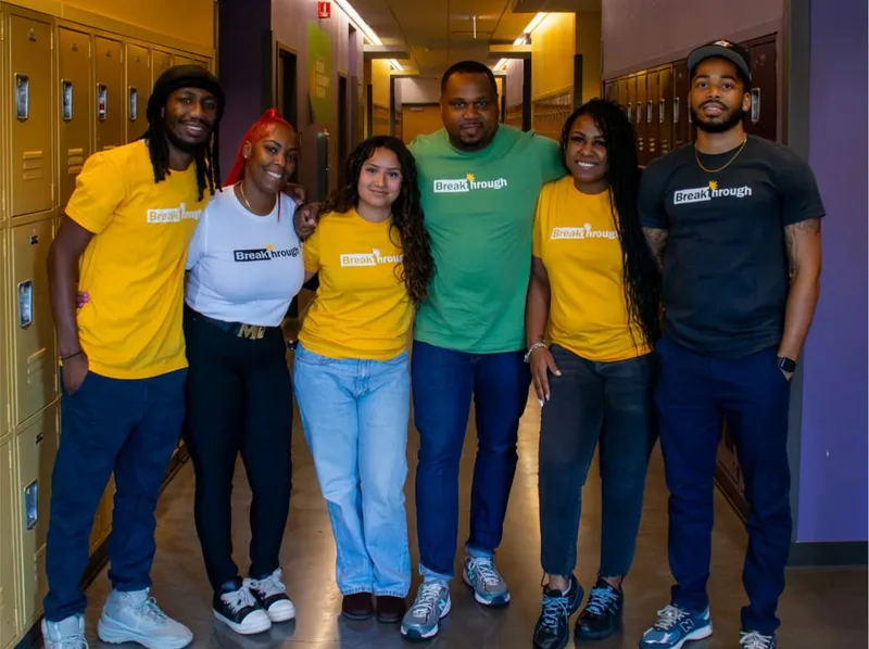 Anthony Hargrove standing with five adults in a school hallway.