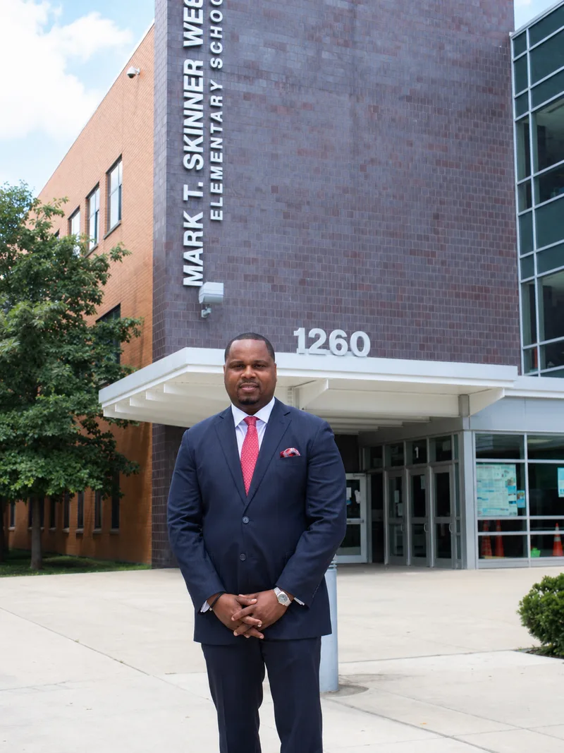 Full length portrait of Anthony Hargrove standing outside Mark T. Skinner West Elementary School.